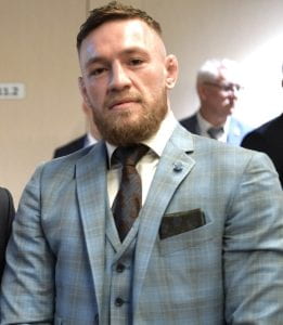 Conor McGregor looking at the camera in a plaid suit